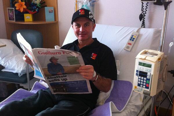 • POSITIVE OUTLOOK: Mike Navybox catches up on the news from his hospital bed.
