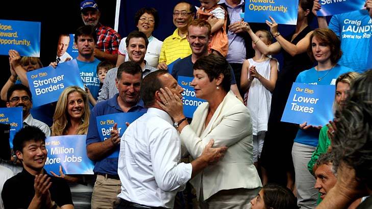 Devoted … Tony Abbott and his wife, Margie, with supporters during a rally on Sunday at Auburn Basketball Centre.