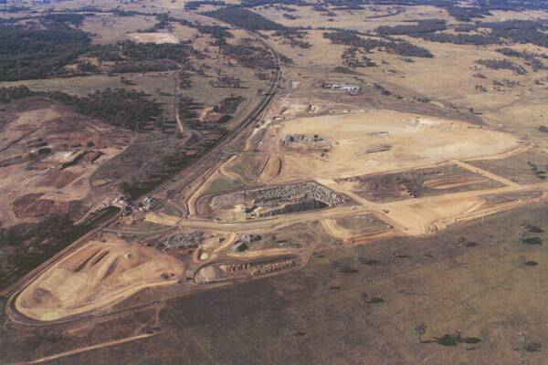 VAST: The $450 million Lynwood quarry at South Marulan will be five times the size of Holcim’s Johnniefelds quarry. The void will be 90 metres deep when complete. At left, construction of a highway interchange is underway, plus work on a rail spur.
