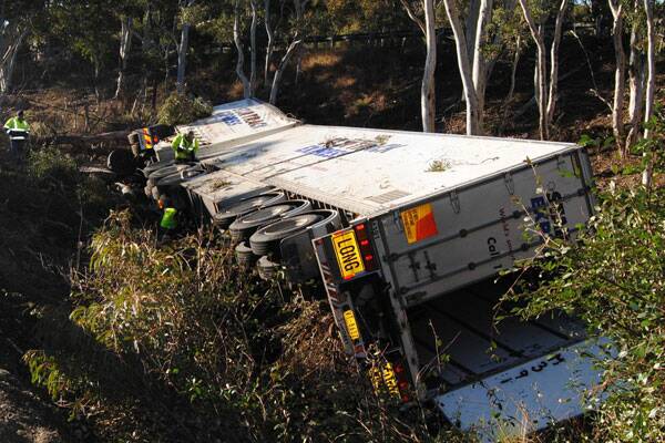 FATALITY: The 47-year-old driver of this rig died when it ran off the Hume Highway near Marulan in the early hours of July 29. A report is being prepared for the coroner.  Photo: CHRIS GORDON.
