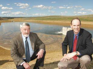 FINALLY: Goulburn Mulwaree Mayor Paul Stephenson and water service manager Greg Finlayson celebrated the commissioning of Goulburn's emergency pipeline from Copford Reach to Sooley Dam yesterday. In the background is a treatment lagoon at Sooley Dam, into which water from the pipeline is pumped.
