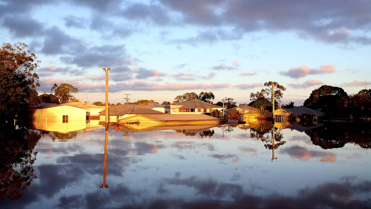 The sun rises over flooded Bundaberg on January 30. Photo: GETTY IMAGES