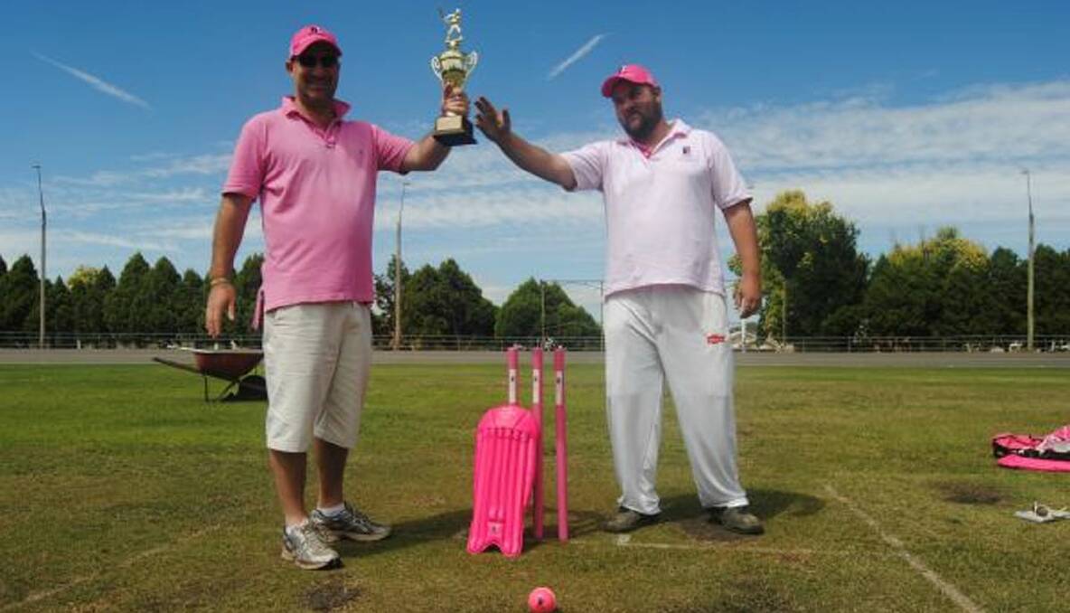SKIPPERS TURN PINK AHEAD OF BATTLE FOR THE ASHES: Tully Park Green captain Mark Griffin dangles the prize before Gold skipper Doug Webster.