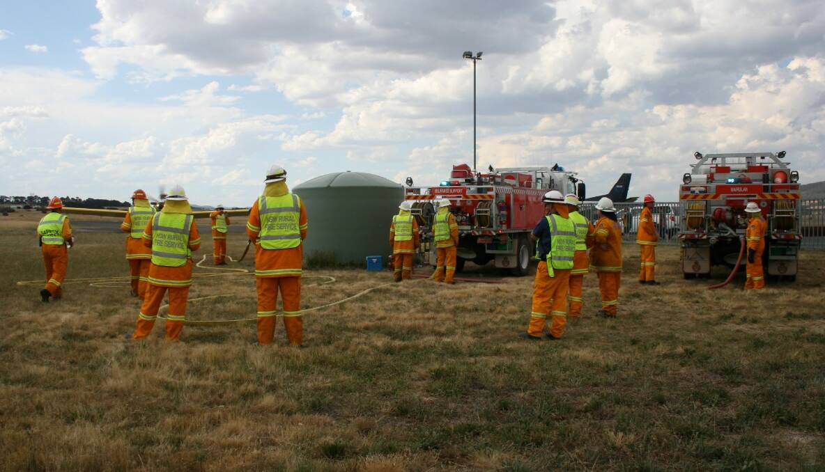 AT THE READY: Fire crews were on hand this afternoon to fill up fixed wing aircraft at Goulburn Airport, commissioned to douse a fire at Mt Wayo.  
