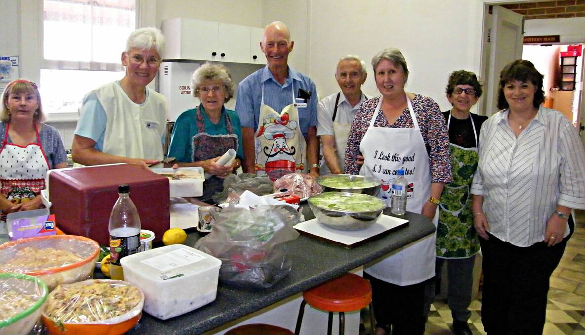 MANY HANDS: June Carpenter, Jan Lawton, Evelyn Harrison, Noel Lawton, Tom Lewis, Sue Robinson, Ida Jarvis and Rachel Bennet were among the volunteers at the Uniting Church’s Christmas lunch at the Wesley Centre. Photo: Lindsay Allen. 