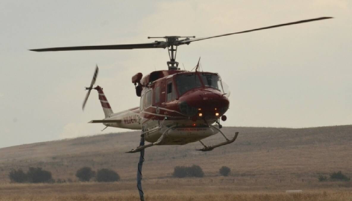 NSW Rural Fire Service fire bombing helicopter preparing to land at Goulburn Airport after fighting the fire 23/12/2013 