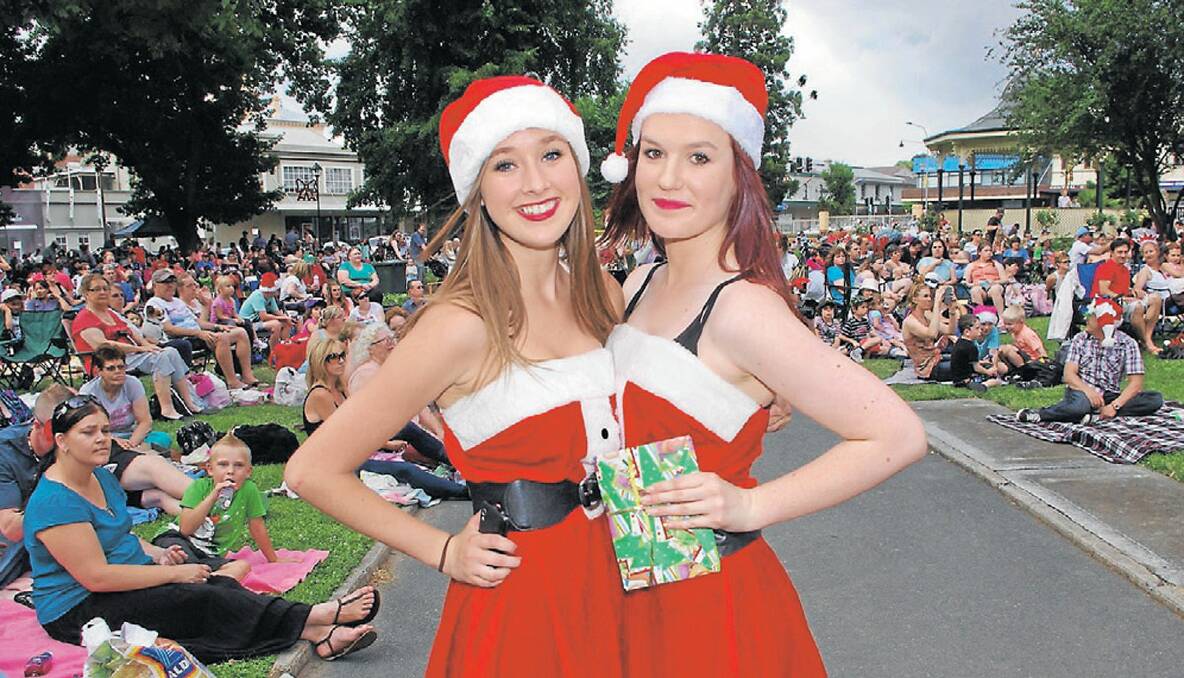 SANTA GIRLS: Holly Costello and Sarah Gower looked the part in their festive gear at Saturday night’s carols. 