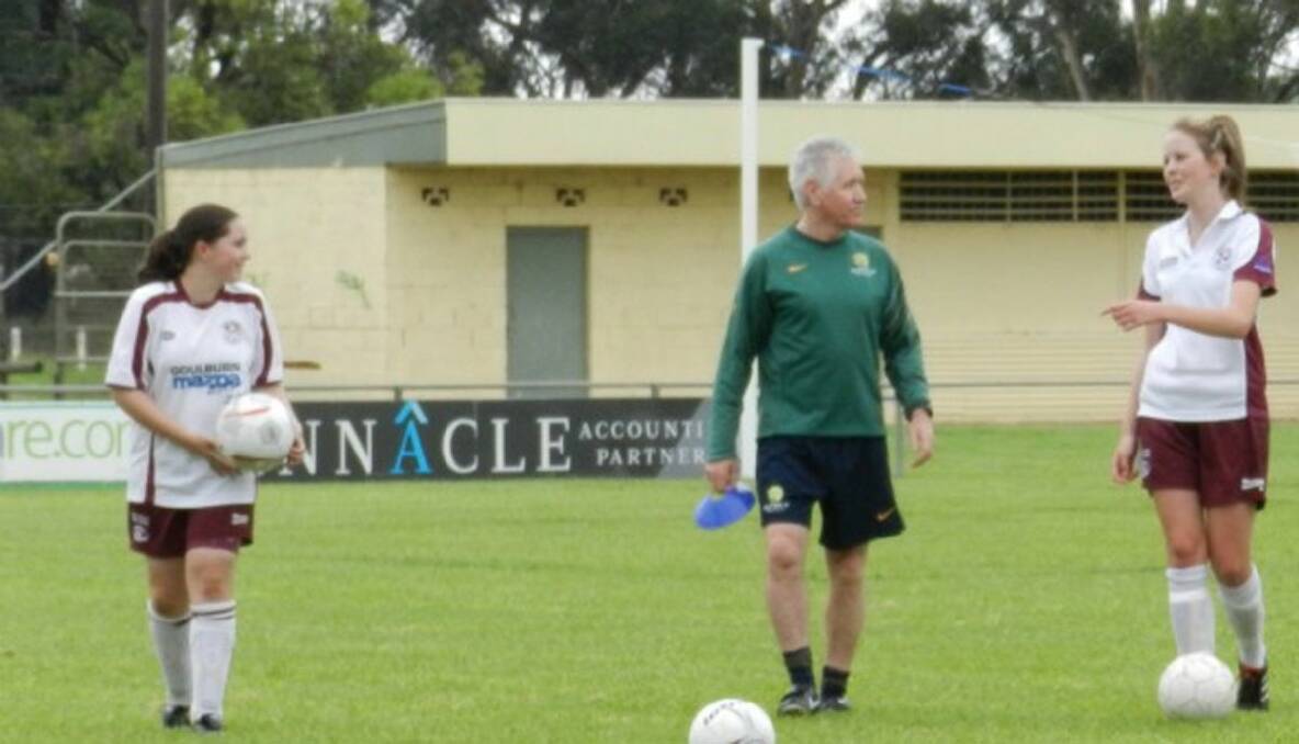 STRIKERS DRESSED TO THE NINES: Kristy Boxsell and Ash Cooper discuss training techniques with Matildas coach Tom Sermanni. 