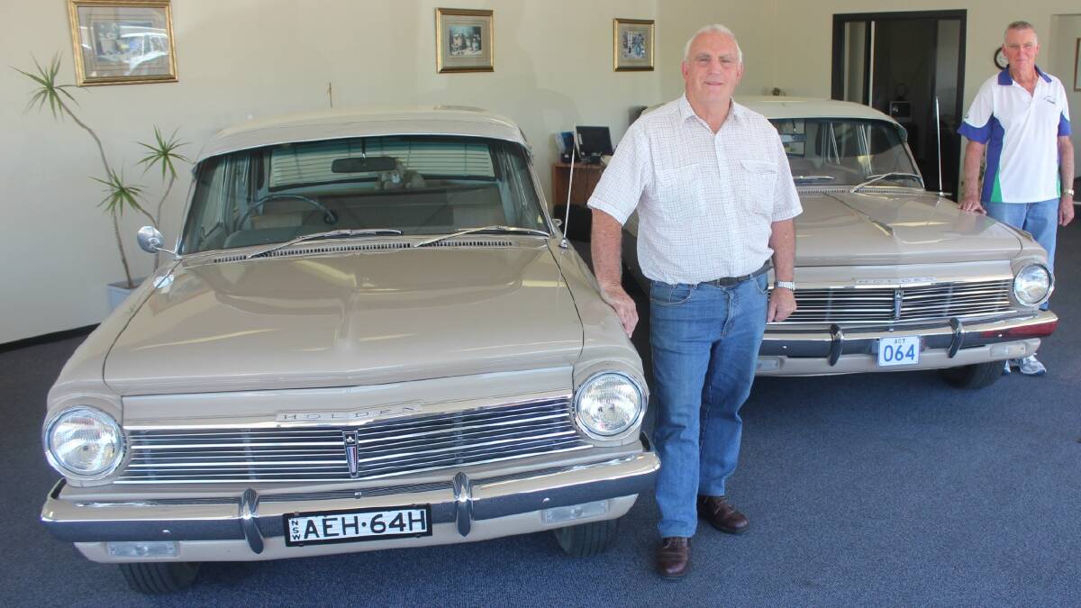   MEMORIES: Goulburn men Dave Robertson (left) and Ken Fowler shared some good memories about the EH Holdens they owned and posed with Phil Robertson’s cars at his showrooms on Auburn St. The EH Holden celebrates its 50th anniversary in 2014.