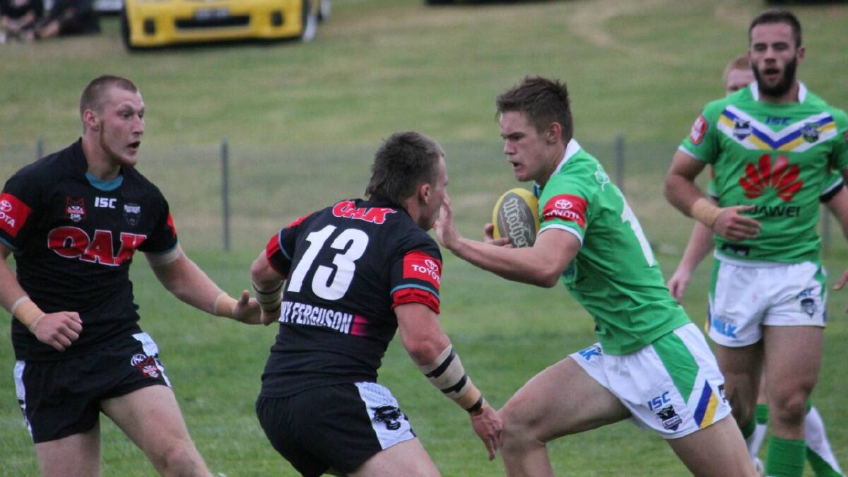  Goulburn boy Jake Lewis palms off the Penrith defence before he gets tackled. 