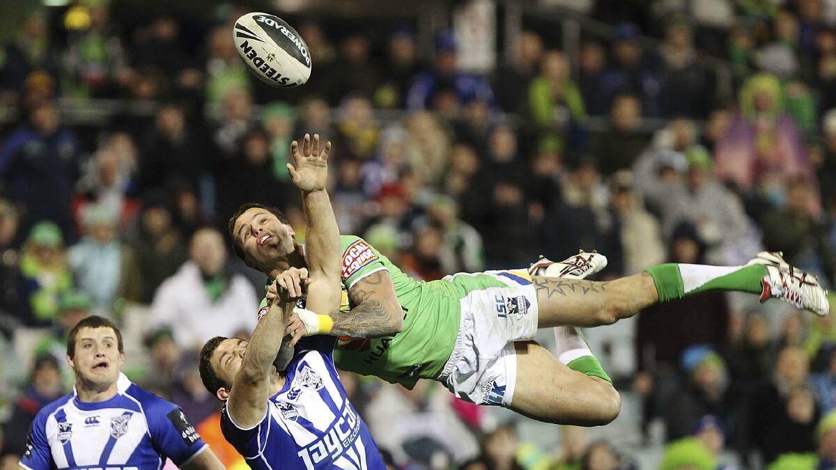 ACROBATS: Raiders winger Sandor Earl leaps above the Bulldogs Krisnan Inu during the teams’ round 25 clash last year. The pair will go head-to-head on Saturday.  Photo: Stefan Postles