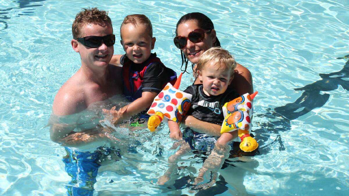 KEEPING COOL: Andrew and Naomi Westcott took a dip with their two sons Jimmy and Isaac at the Goulburn Aquatic Centre on Sunday morning as the mercury rose to 35 degrees. Photo: TOM SEBO.
