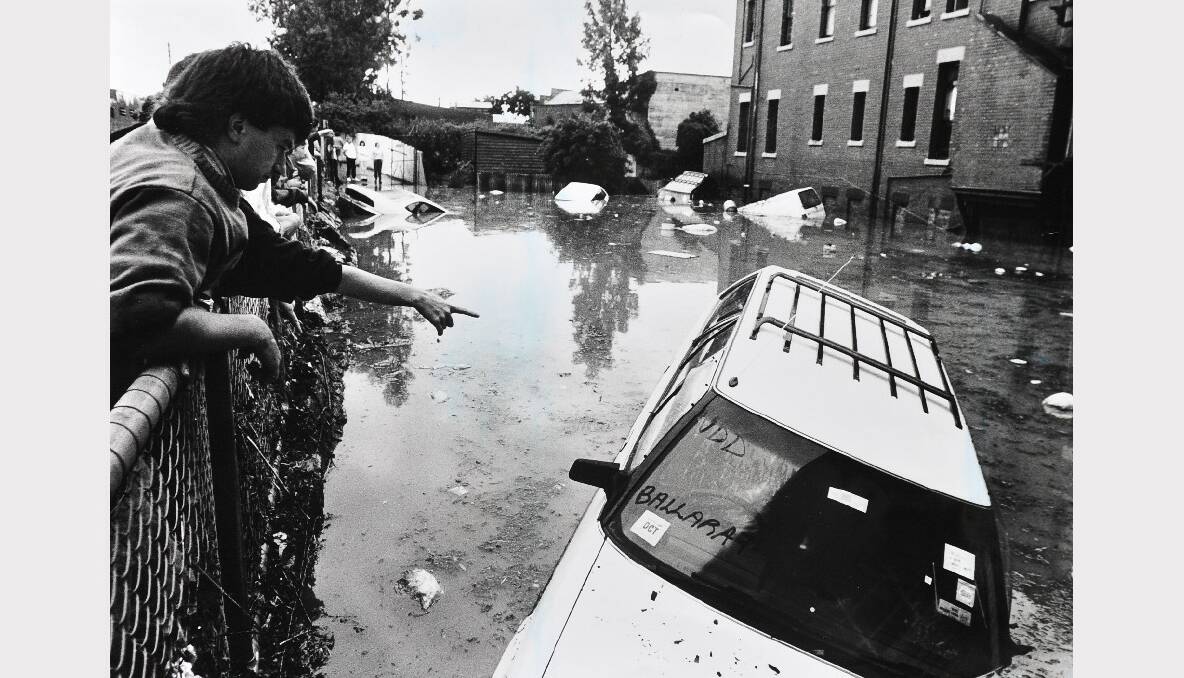 NEW YEAR'S EVE, 1991: Lydiard Street North and surrounding areas were submerged by floodwaters, when 76mm fell on Ballarat as the city bid farewell to 1991. A crane was called to life 15 Mitsubishi vehicles worth about $500,000, which were written off after being submerged in a yard below S.F Motors Mercedes Benz workshop in Lydiard Street North.