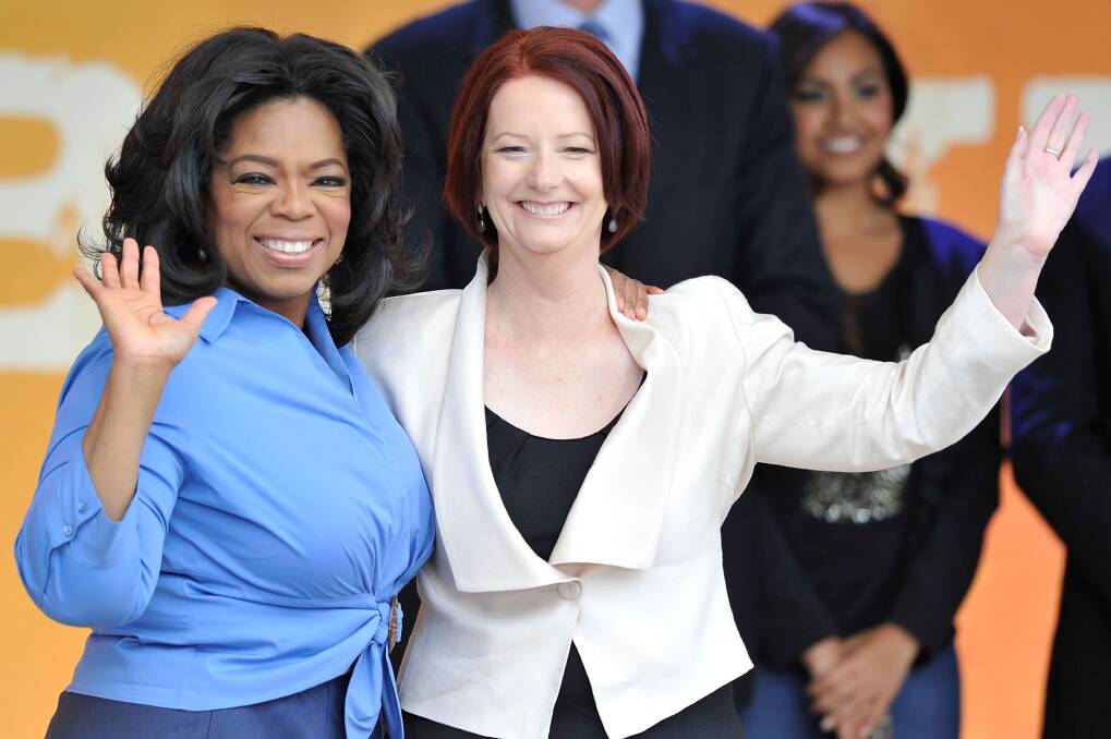 Oprah Winfrey and Prime Minister Julia Gillard waves during a public event at Federation Square on December 10, 2010 in Melbourne, Australia. Photo: Getty Images