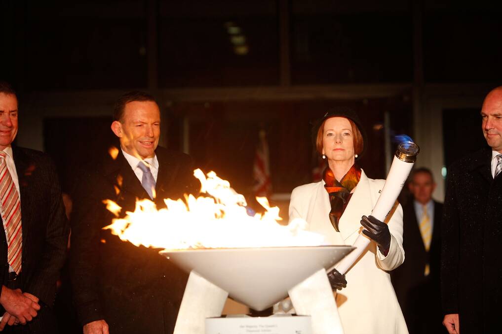 Julia Gillard and Tony Abbott light a ceremonial beacon to mark the Queen's Diamond Jubilee at Parliament House on June 4, 2012 in Canberra. Photo: Getty Images