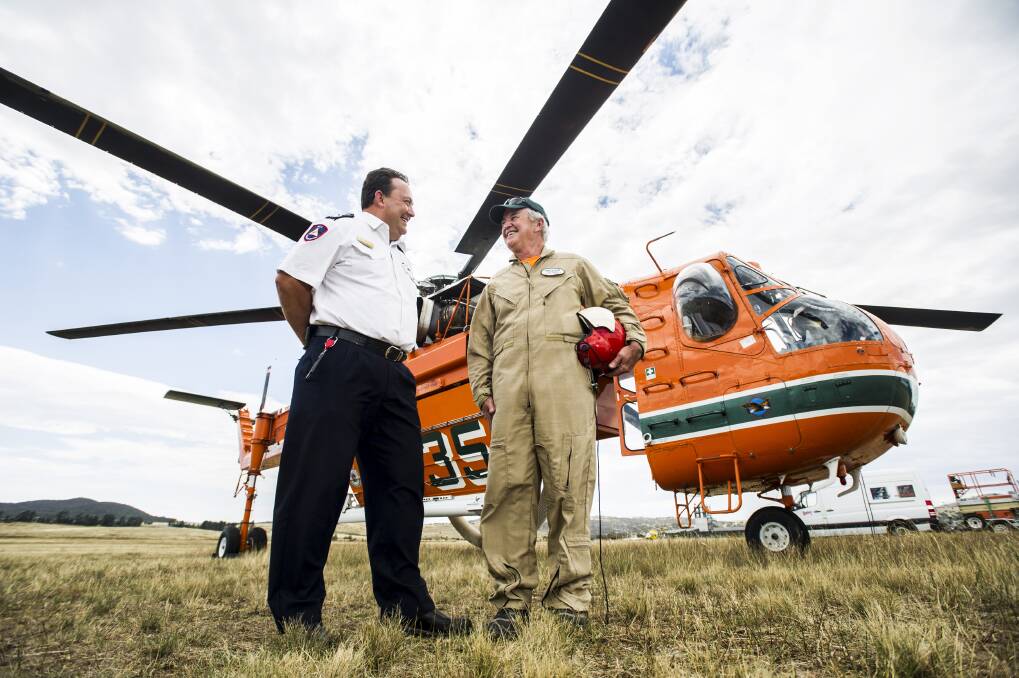 ACT Chief RFS Officer Andrew Stark talks with SkyCrane pilot Brian Pilmer at the RFS in Hume on January 12, 2013. Photo: Rohan Thomson/The Canberra Times